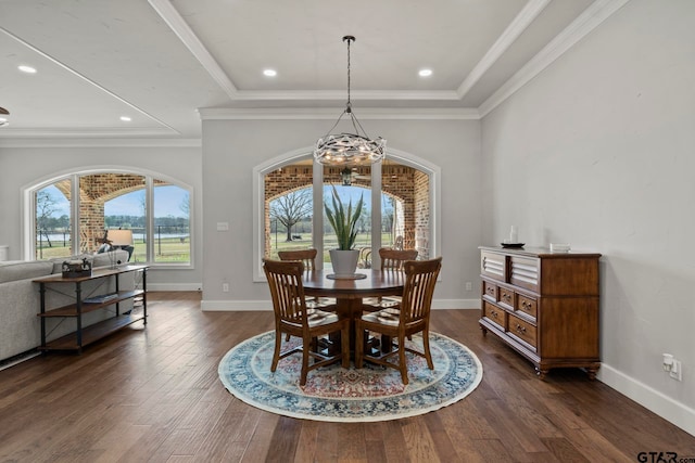 dining area with a notable chandelier, dark hardwood / wood-style floors, and crown molding