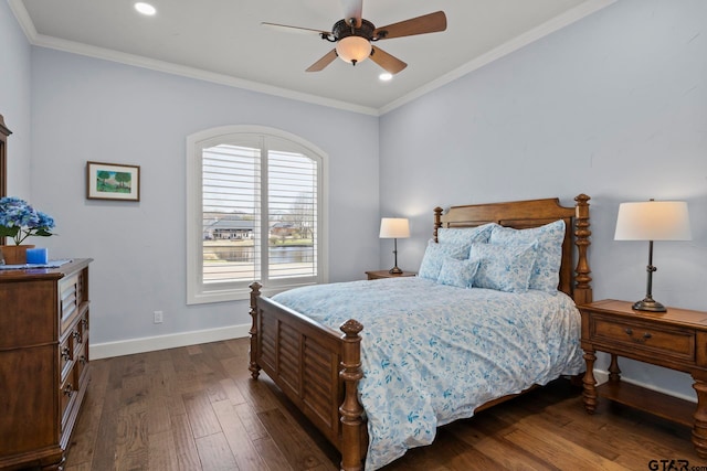 bedroom with dark wood-type flooring, ceiling fan, and ornamental molding