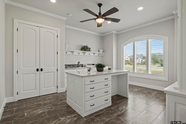 interior space with ceiling fan, white cabinetry, and crown molding