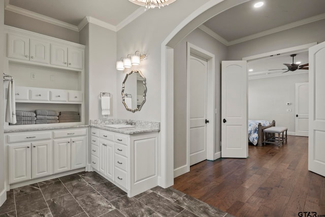 bathroom featuring hardwood / wood-style floors, ceiling fan, vanity, and crown molding