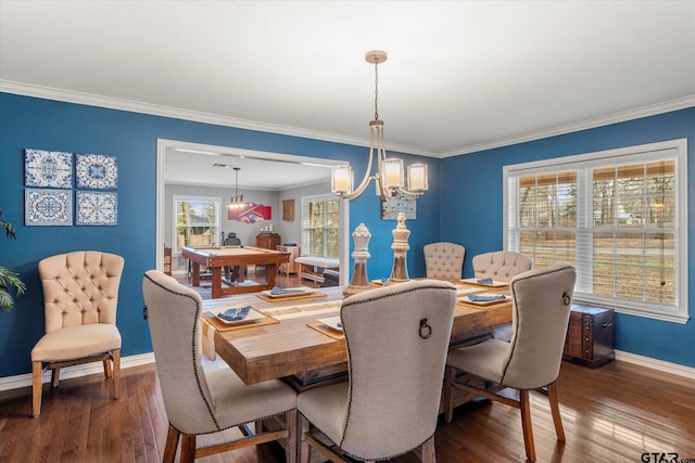 dining area with ornamental molding, dark wood-type flooring, and an inviting chandelier