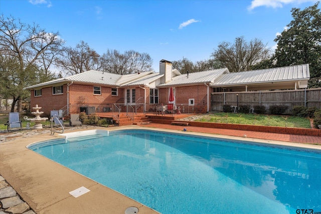 view of swimming pool featuring a wooden deck