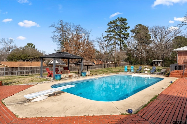 view of pool with a patio, a storage unit, a gazebo, and a diving board