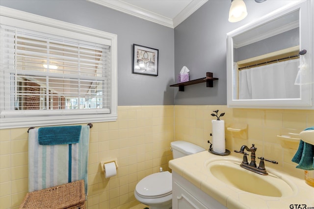 bathroom with tile walls, vanity, crown molding, and toilet