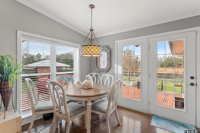 dining space featuring hardwood / wood-style floors, a wealth of natural light, and ornamental molding