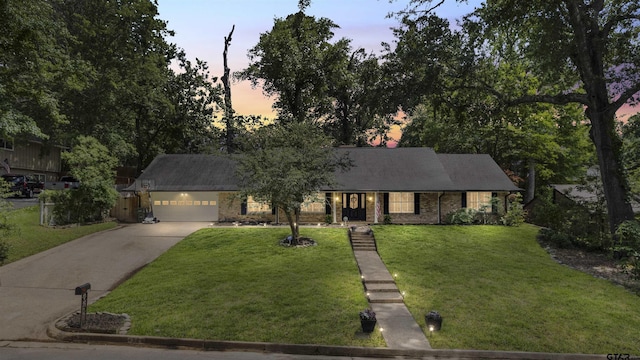 1723 Kensington Dr, Tyler, TX 75703 - view of front of house with concrete driveway, a yard, a garage, and a porch
