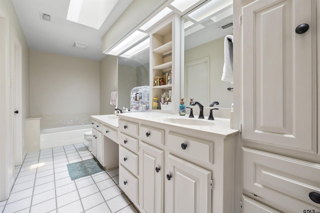 1723 Kensington Dr, Tyler, TX 75703 - full bathroom featuring double vanity, tile patterned flooring, toilet, a bath, and a skylight