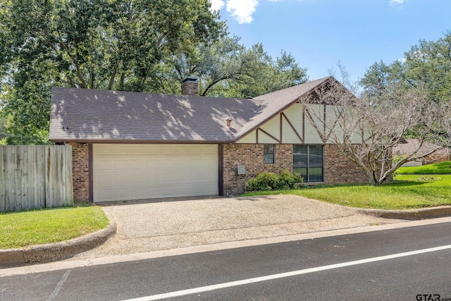 802 Carriage Dr, Tyler, TX 75703 - tudor house with brick siding, concrete driveway, a garage, and a chimney