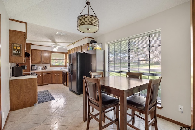 802 Carriage Dr, Tyler, TX 75703 - dining area with a textured ceiling, a ceiling fan, and light tile patterned flooring