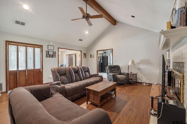 802 Carriage Dr, Tyler, TX 75703 - living area featuring beam ceiling, ceiling fan, a fireplace, wood finished floors, and high vaulted ceiling