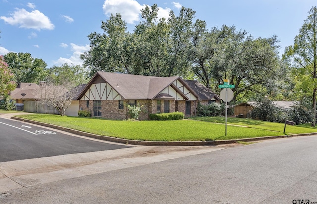 802 Carriage Dr, Tyler, TX 75703 - tudor house featuring a front lawn