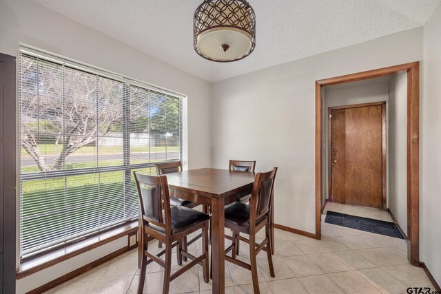 802 Carriage Dr, Tyler, TX 75703 - dining room with light tile patterned floors and a textured ceiling