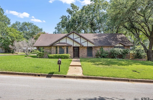 802 Carriage Dr, Tyler, TX 75703 - tudor house featuring a front lawn and brick siding
