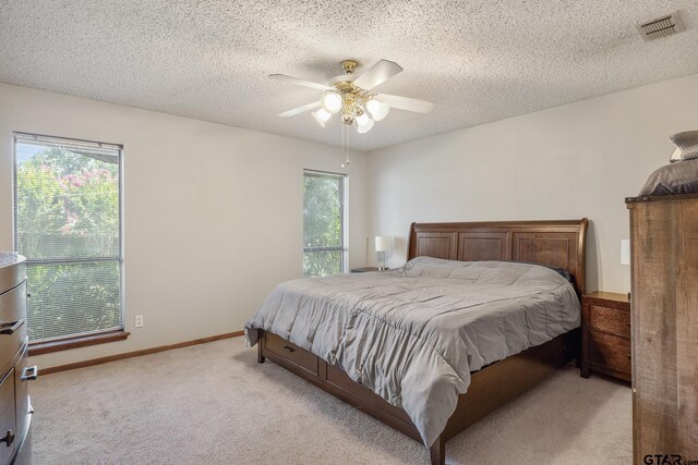 802 Carriage Dr, Tyler, TX 75703 - carpeted bedroom with a textured ceiling and ceiling fan