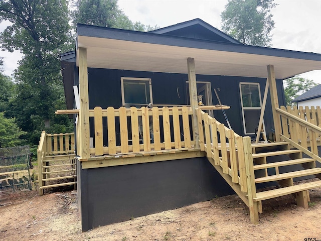 view of front of property with stairs and fence