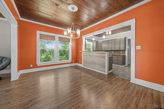 230 N Henderson St, Rusk, TX 75785 - unfurnished dining area featuring dark wood-style flooring, an inviting chandelier, crown molding, and wooden ceiling
