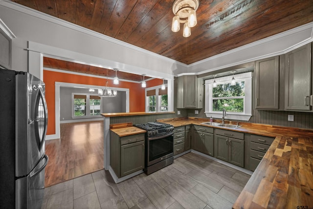 230 N Henderson St, Rusk, TX 75785 - kitchen featuring a sink, wood counters, appliances with stainless steel finishes, crown molding, and wooden ceiling