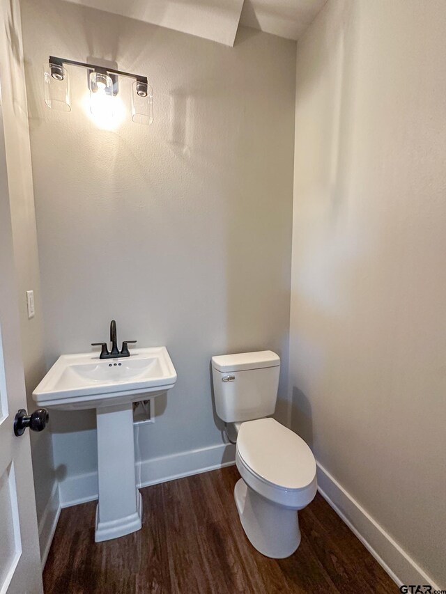 7449 Crk 314, Henderson, TX 75652 - half bath featuring wood finished floors, toilet, and baseboards