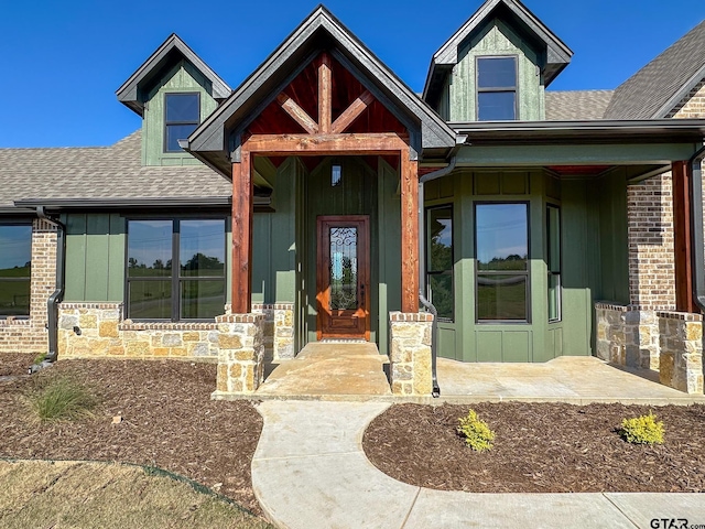 7449 Crk 314, Henderson, TX 75652 - view of front facade featuring roof with shingles, stone siding, and board and batten siding
