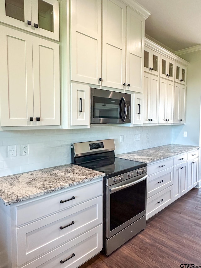 7449 Crk 314, Henderson, TX 75652 - kitchen with appliances with stainless steel finishes, crown molding, dark wood-type flooring, backsplash, and glass insert cabinets