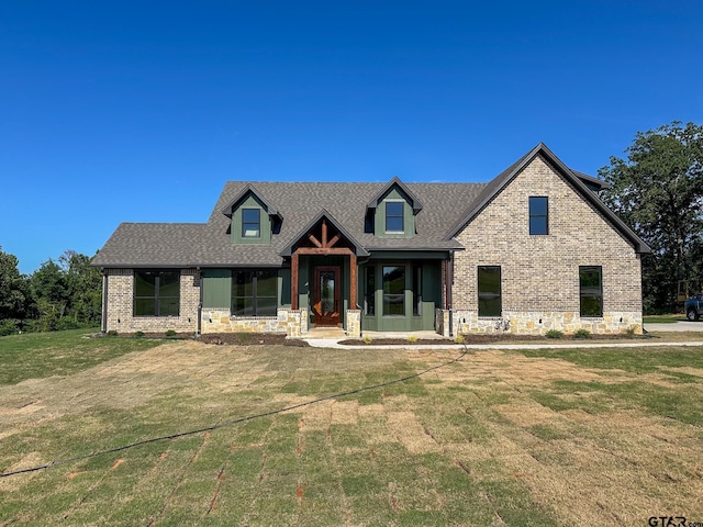 7449 Crk 314, Henderson, TX 75652 - view of front facade featuring a front yard, a shingled roof, brick siding, and stone siding