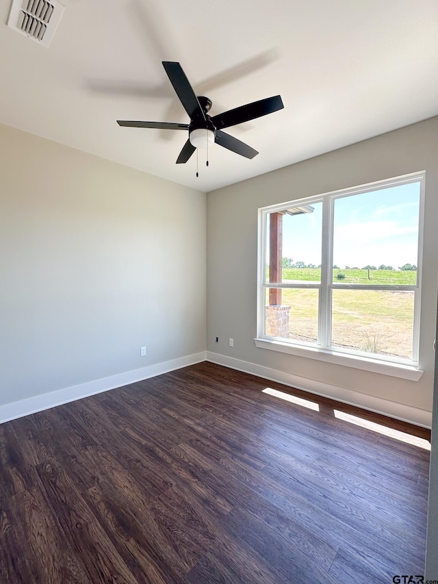 7449 Crk 314, Henderson, TX 75652 - spare room featuring dark wood-type flooring, baseboards, and ceiling fan