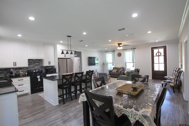 19379 Cedarpark Pl, Lindale, TX 75771 - dining space featuring recessed lighting, wood finished floors, ceiling fan, and crown molding