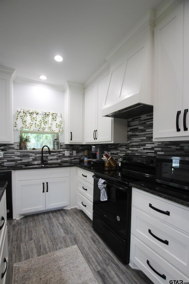 19379 Cedarpark Pl, Lindale, TX 75771 - kitchen featuring black range with electric cooktop, backsplash, white cabinets, recessed lighting, and dark wood finished floors