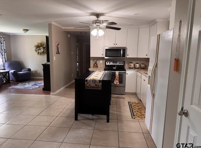 kitchen with light tile patterned floors, white cabinets, backsplash, and stainless steel appliances