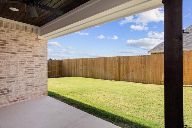 view of yard with ceiling fan and a patio area