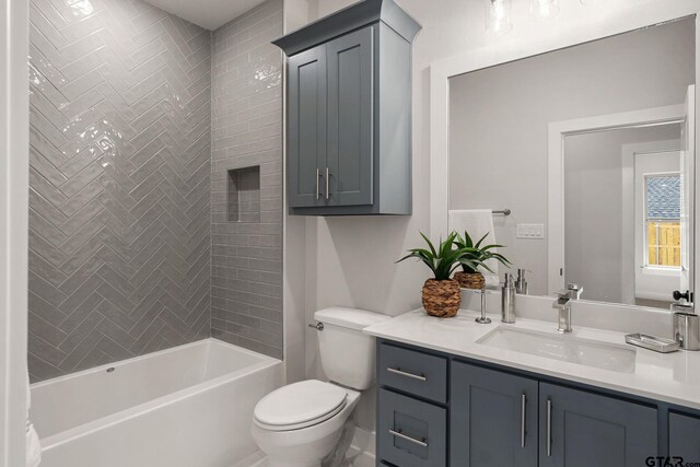 full bathroom featuring vanity, toilet, and tiled shower / bath combo