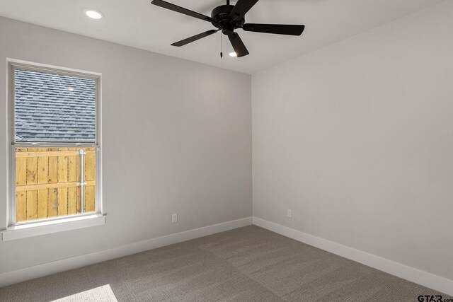 unfurnished room featuring ceiling fan and carpet