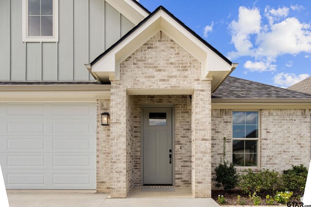 view of exterior entry with a garage