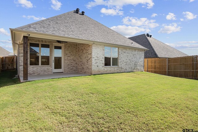 rear view of property with a patio area and a yard