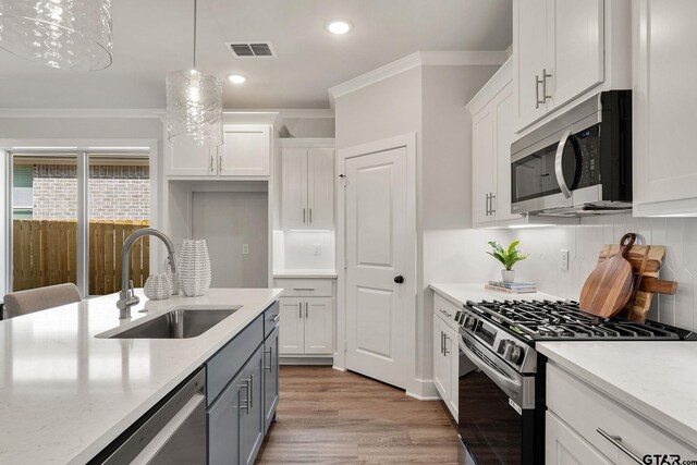 kitchen featuring white cabinets, appliances with stainless steel finishes, and sink