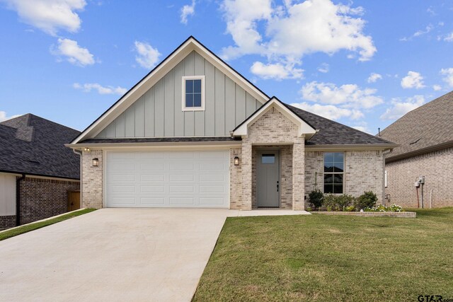 view of front of home with a garage and a front lawn