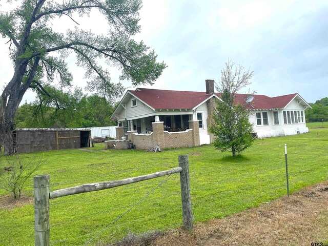 205 N Sixth St, Mexia, TX 76667 - back of property with a chimney