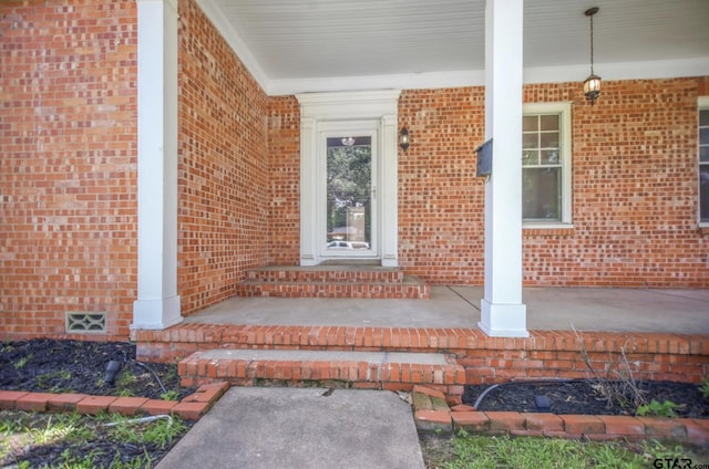 705 S Vine Ave, Tyler, TX 75701 - doorway to property featuring covered porch and brick siding
