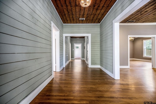 705 S Vine Ave, Tyler, TX 75701 - hallway with a chandelier, wood ceiling, wood walls, dark wood-style floors, and crown molding