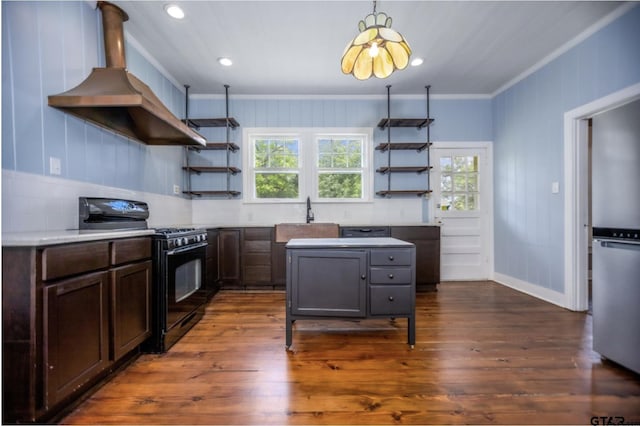 705 S Vine Ave, Tyler, TX 75701 - kitchen featuring black gas stove, open shelves, wall chimney range hood, ornamental molding, and dark wood-style flooring