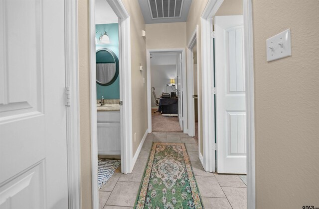 2531 Guinn Farms Rd, Tyler, TX 75707 - corridor featuring light tile patterned flooring and a sink