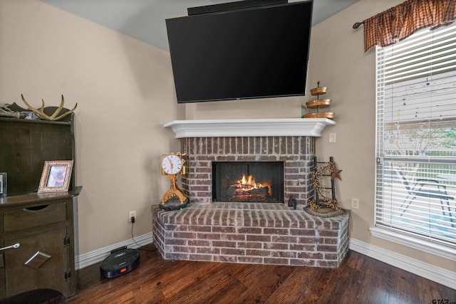 2531 Guinn Farms Rd, Tyler, TX 75707 - detailed view of baseboards, wood finished floors, and a brick fireplace