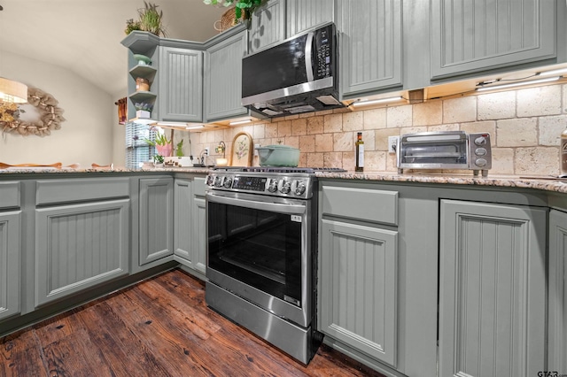 2531 Guinn Farms Rd, Tyler, TX 75707 - kitchen with appliances with stainless steel finishes, gray cabinetry, decorative backsplash, dark wood-type flooring, and lofted ceiling
