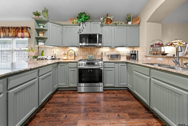 2531 Guinn Farms Rd, Tyler, TX 75707 - kitchen featuring stainless steel appliances, a sink, open shelves, and decorative backsplash