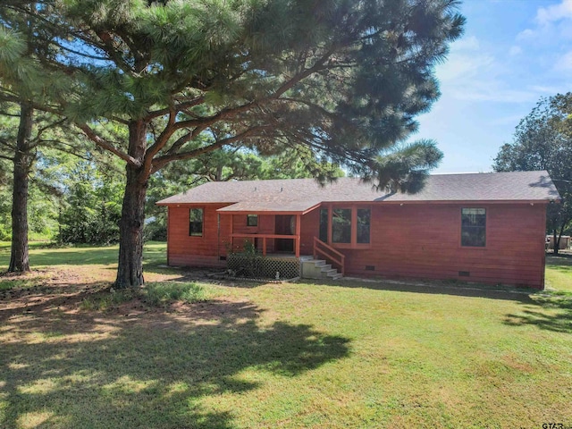 back of property featuring a lawn