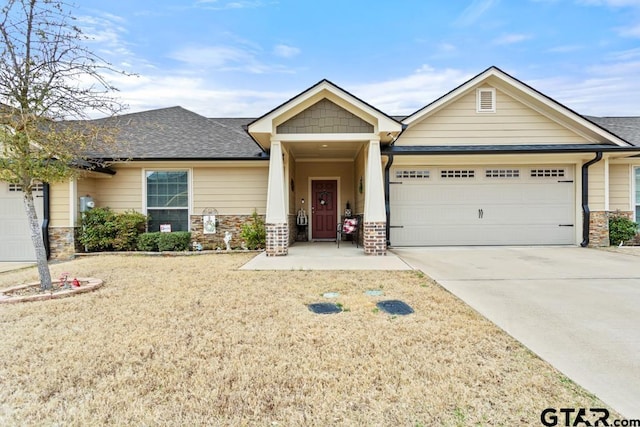 craftsman-style house featuring a garage, concrete driveway, roof with shingles, and stone siding