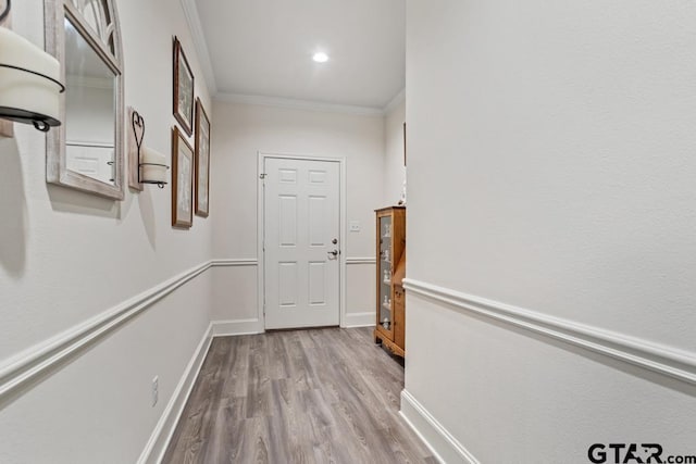 corridor with recessed lighting, baseboards, crown molding, and wood finished floors