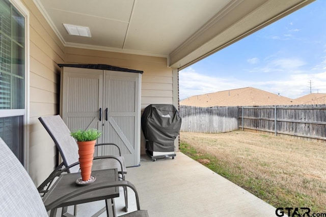 view of patio / terrace with grilling area and a fenced backyard