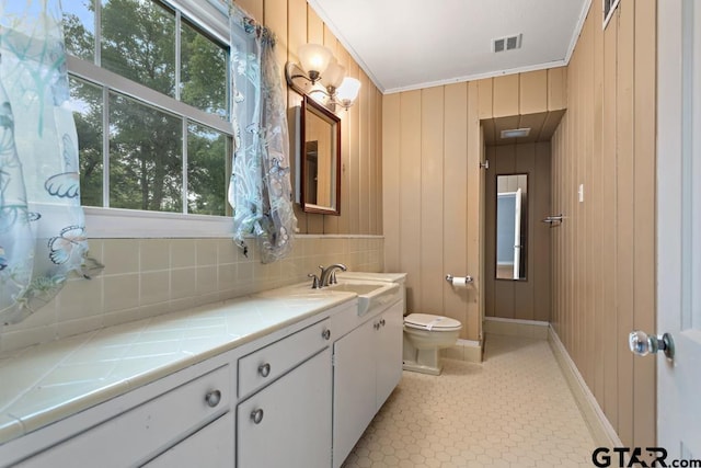 2318 S Chilton Ave, Tyler, TX 75701 - bathroom with vanity, tasteful backsplash, and ornamental molding