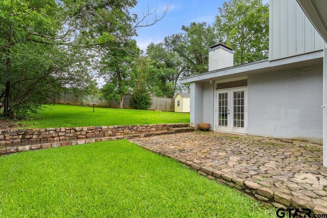 2318 S Chilton Ave, Tyler, TX 75701 - fenced backyard featuring french doors, a patio, and a shed